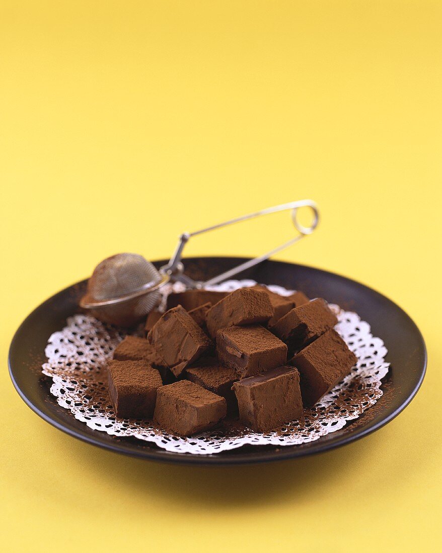 Chocolate squares sprinkled with cocoa powder