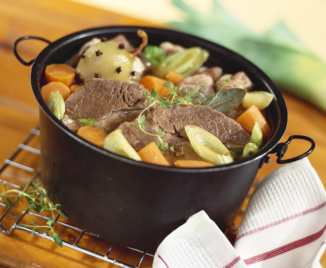 Boiled beef with vegetables in stock pot