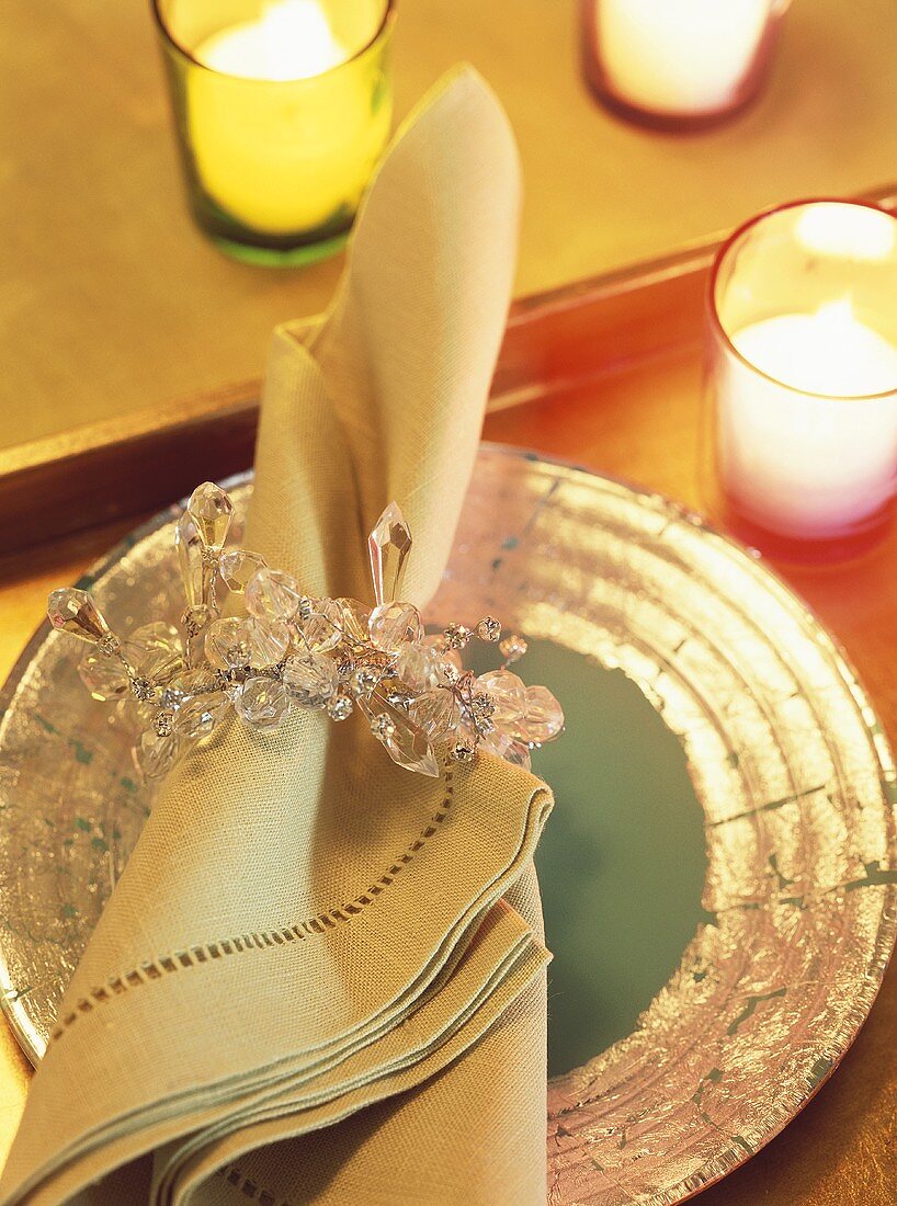 Festive place-setting: gold-rimmed plate and fabric napkin