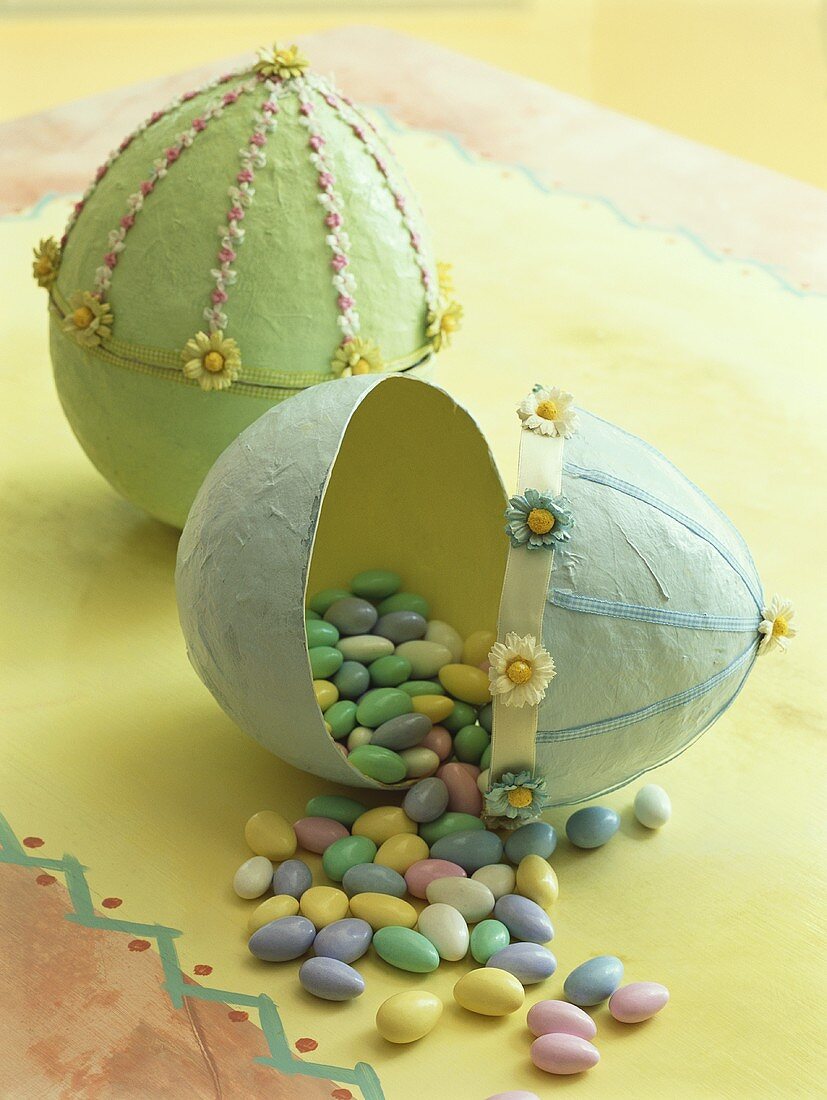 Sugar eggs falling out of large paper Easter egg