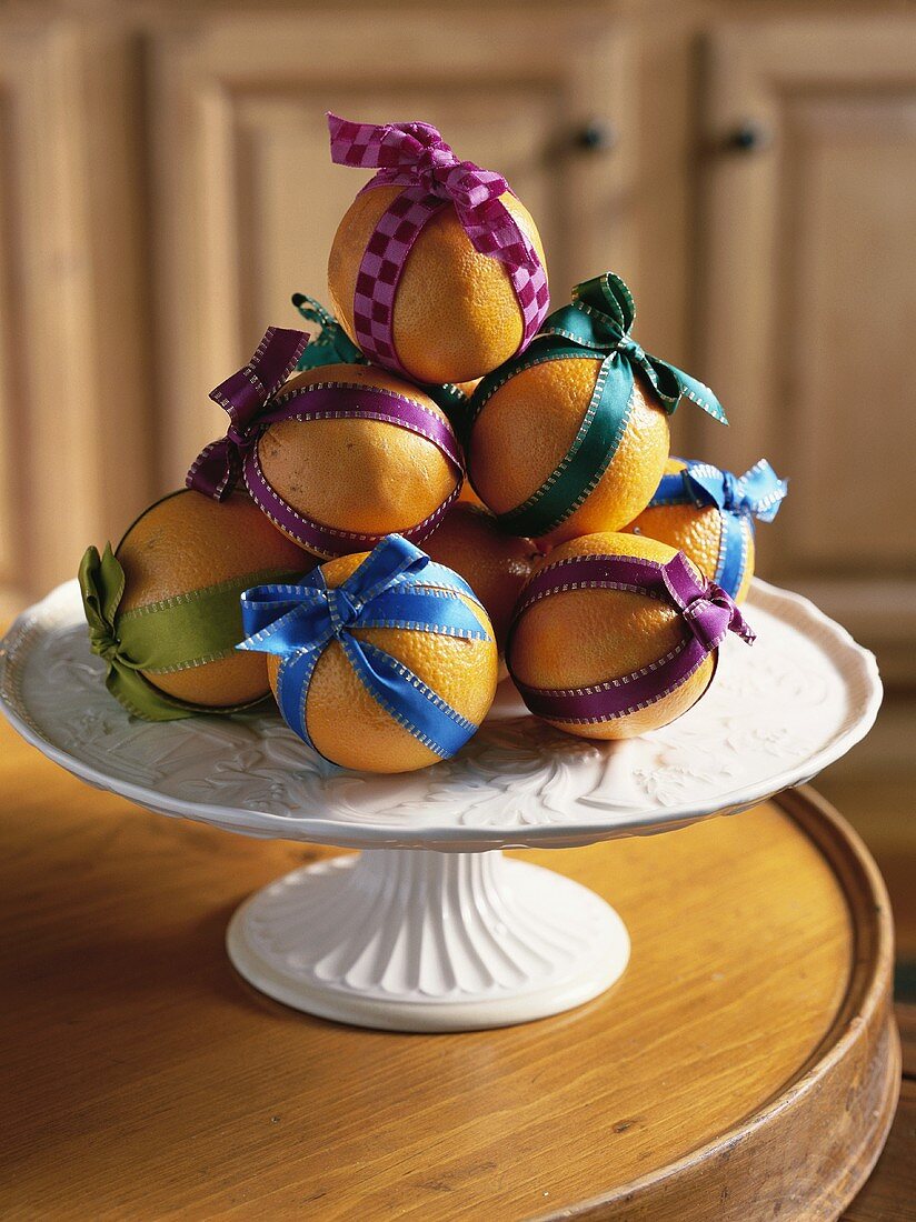 Christmas decoration of oranges with coloured ribbons