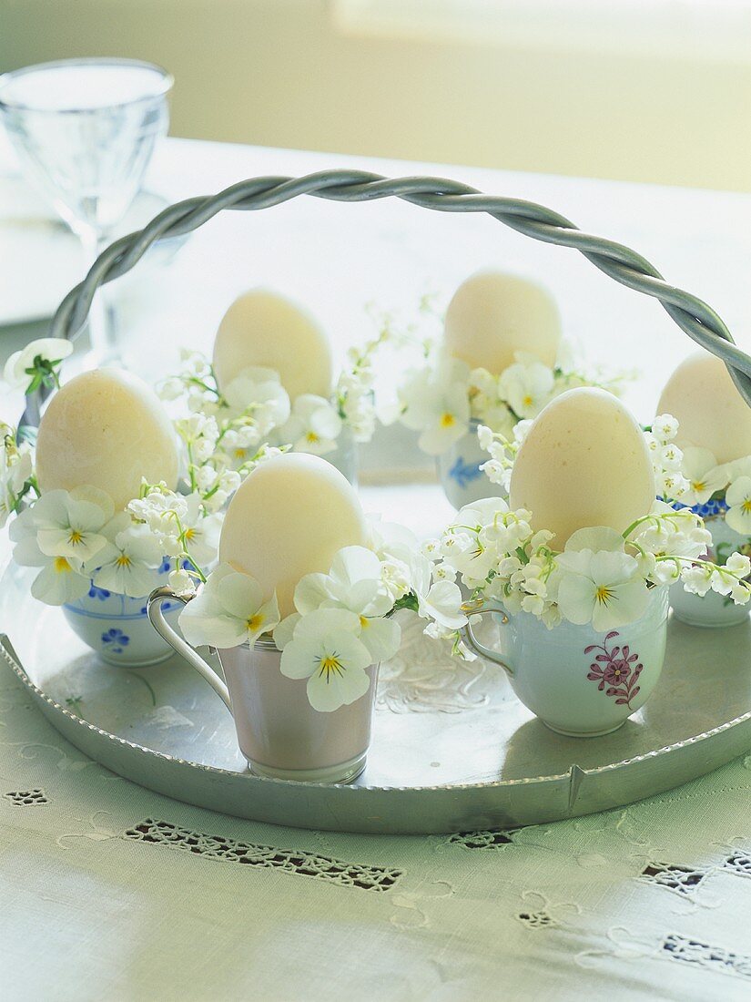 weiße Eier, dekoriert mit Blüten, zu Ostern