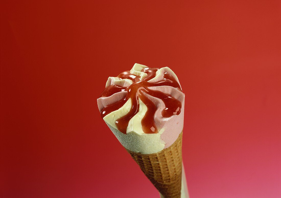 Strawberry & vanilla ice cream cone with strawberry sauce