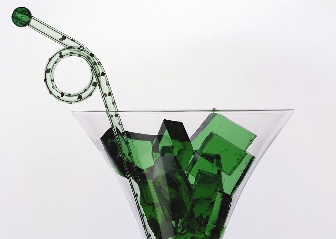 Green jelly cubes (woodruff jelly) in a glass