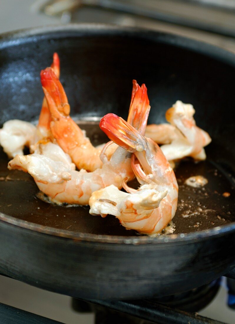 Frying shrimps in a frying pan