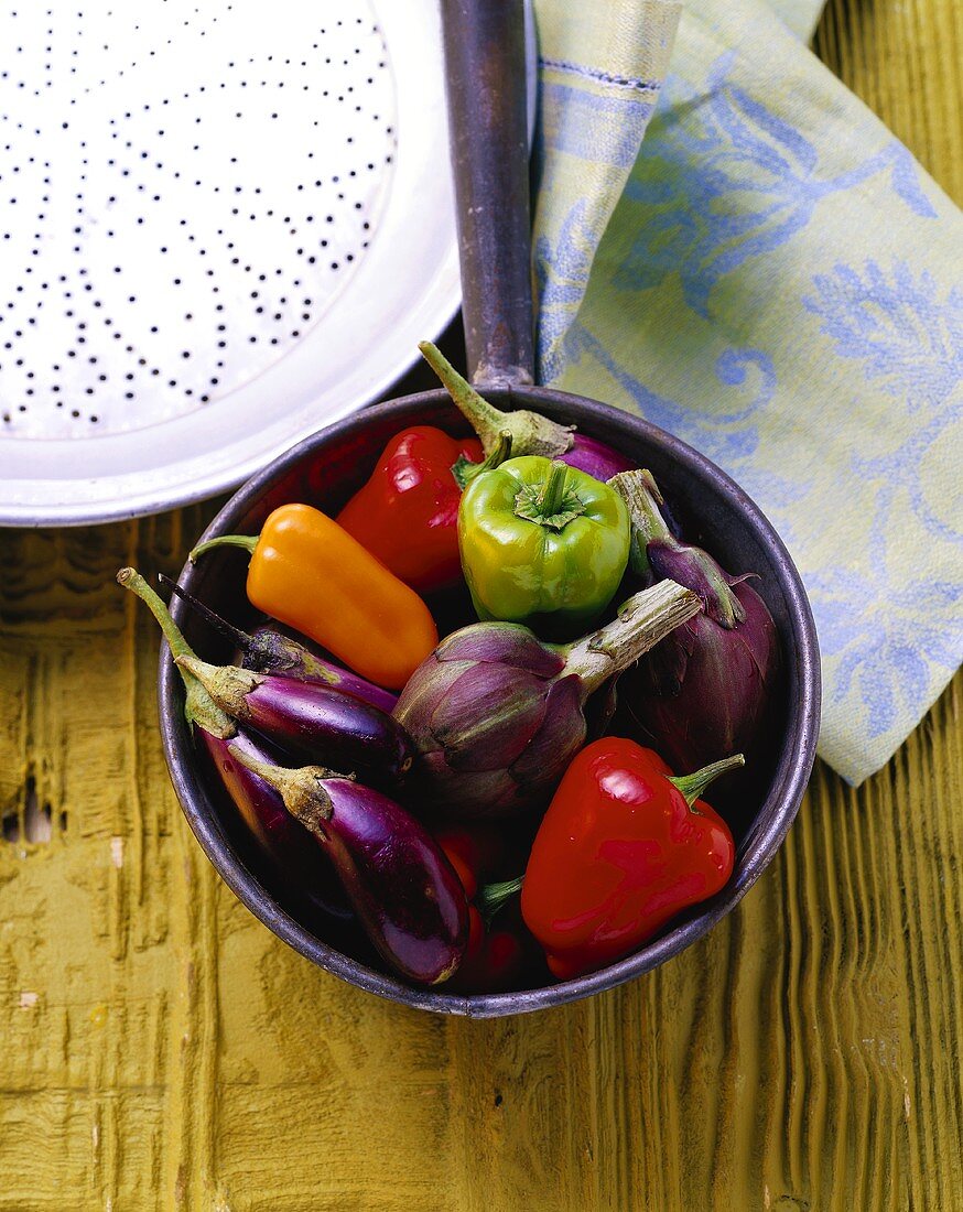 Still life with peppers, aubergines and artichokes