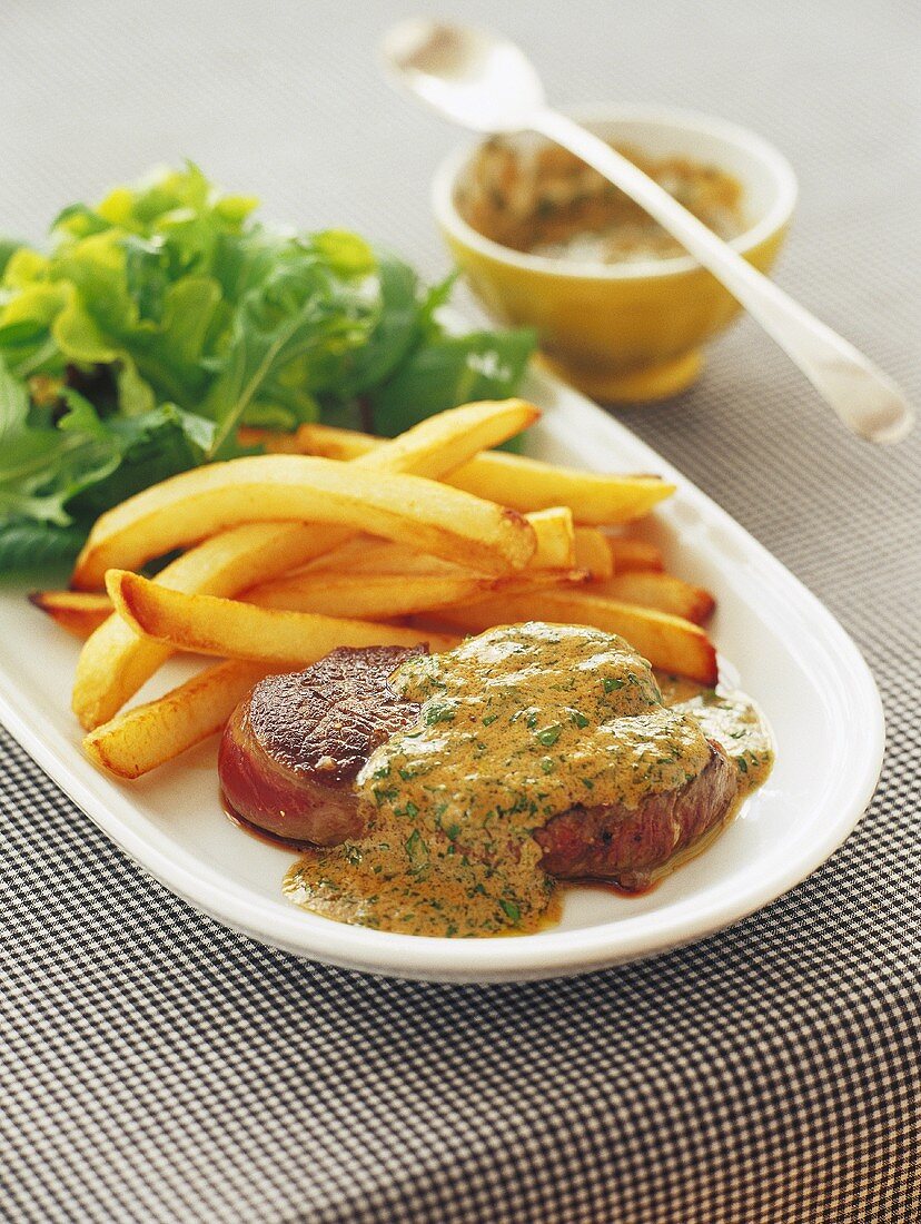 Beef fillet with mustard sauce, chips and salad