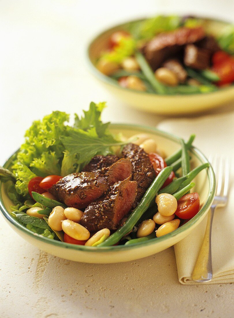 Lamb fillet with mustard seeds on bean salad
