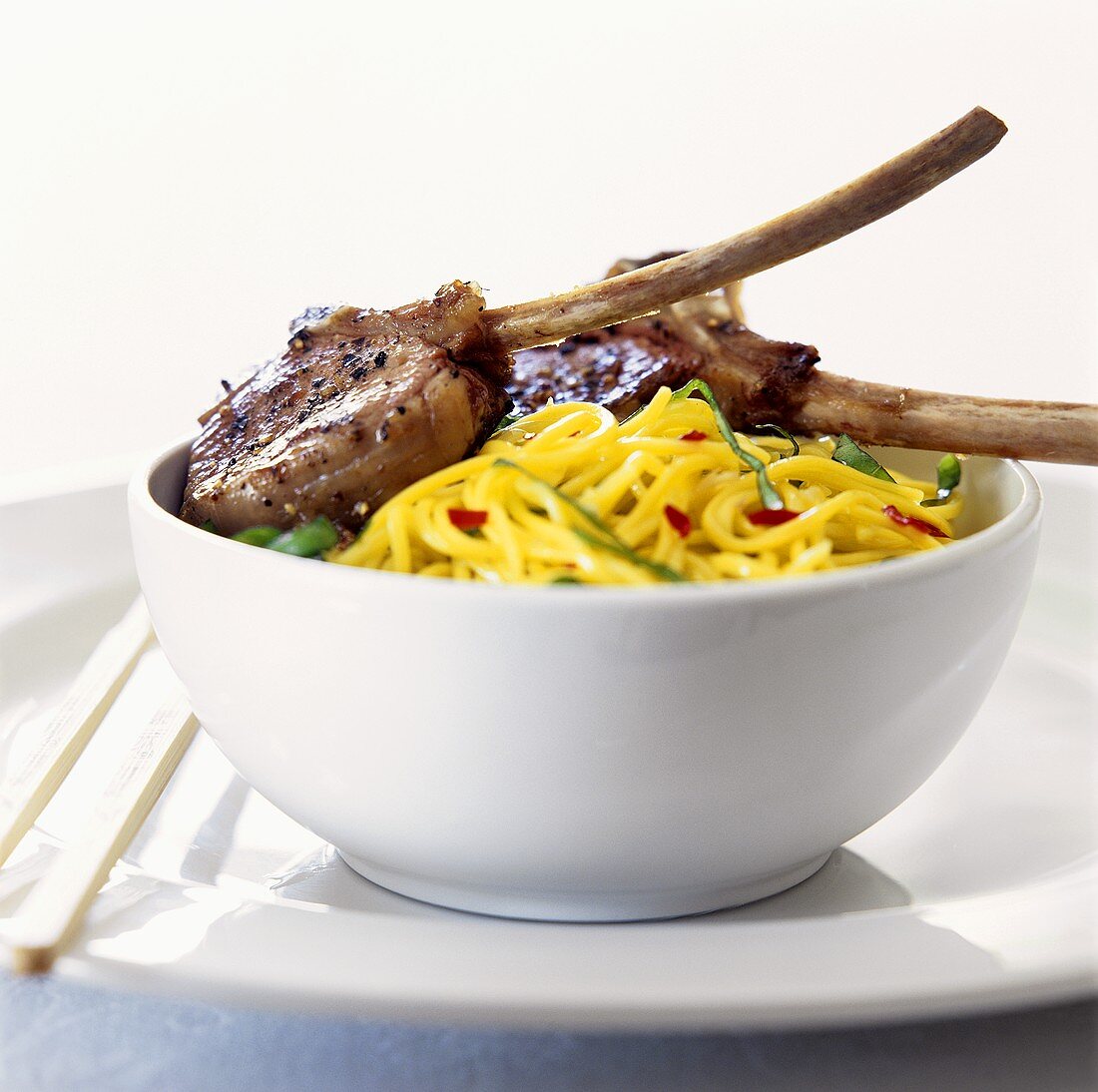 Lamb cutlets on yellow noodles