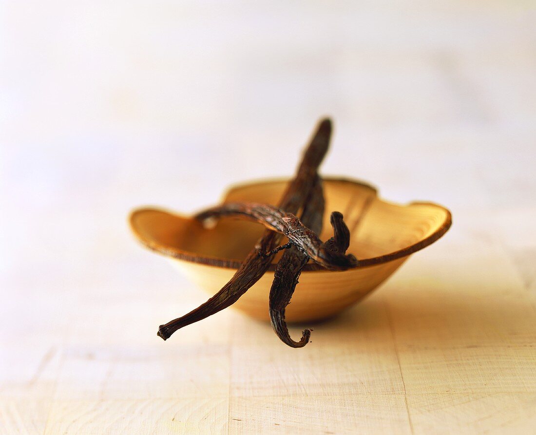 Vanilla pods in wooden bowl