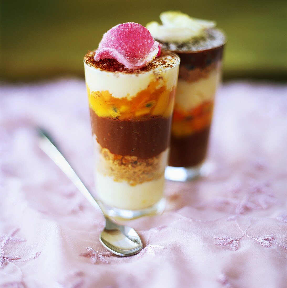 Layered yoghurt & passion fruit dessert with candied rose petal