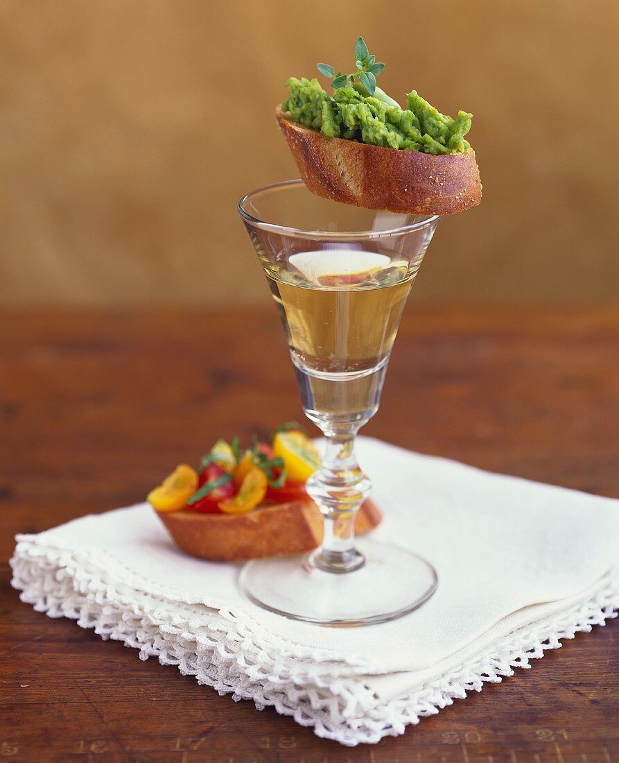 Crostini with avocado puree & with cocktail tomatoes & wine