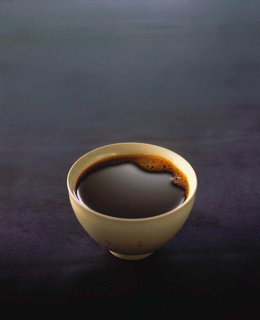 Black coffee in drinking bowl