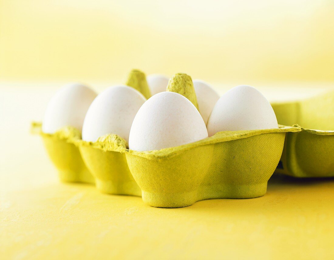 Six white eggs in egg box