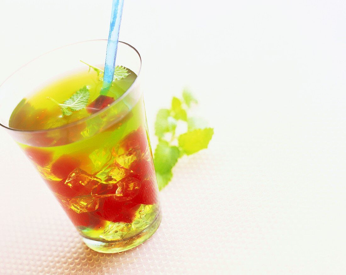 Vodka and lemon drink with red and green jelly