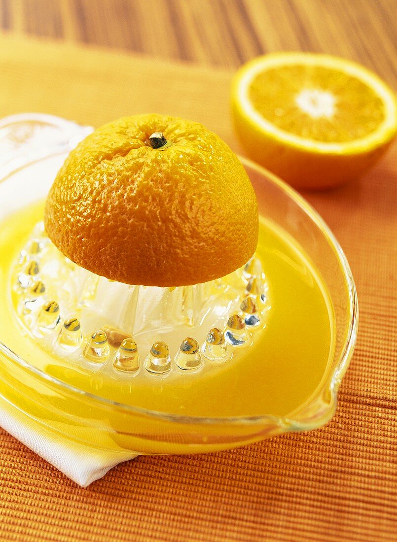 Half an orange on citrus squeezer