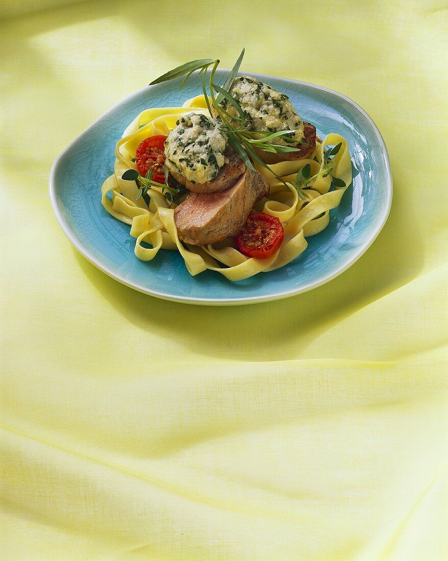 Pork fillets on ribbon pasta