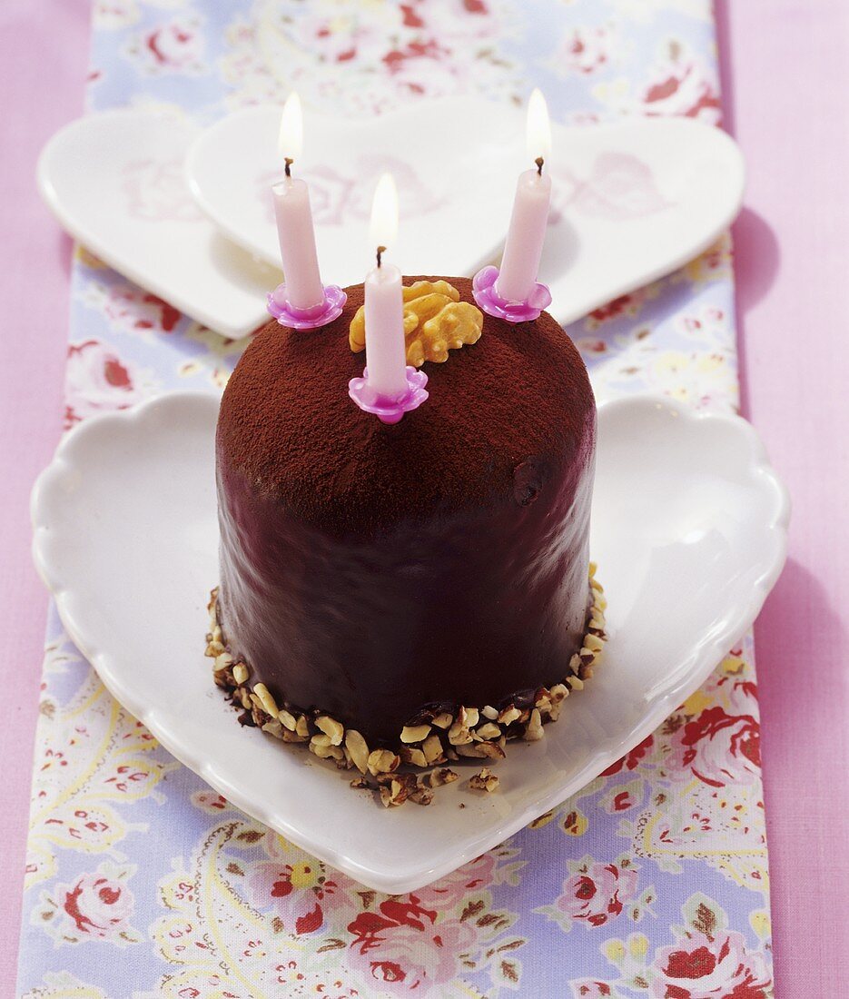 Mini chocolate cake with walnuts and three candles