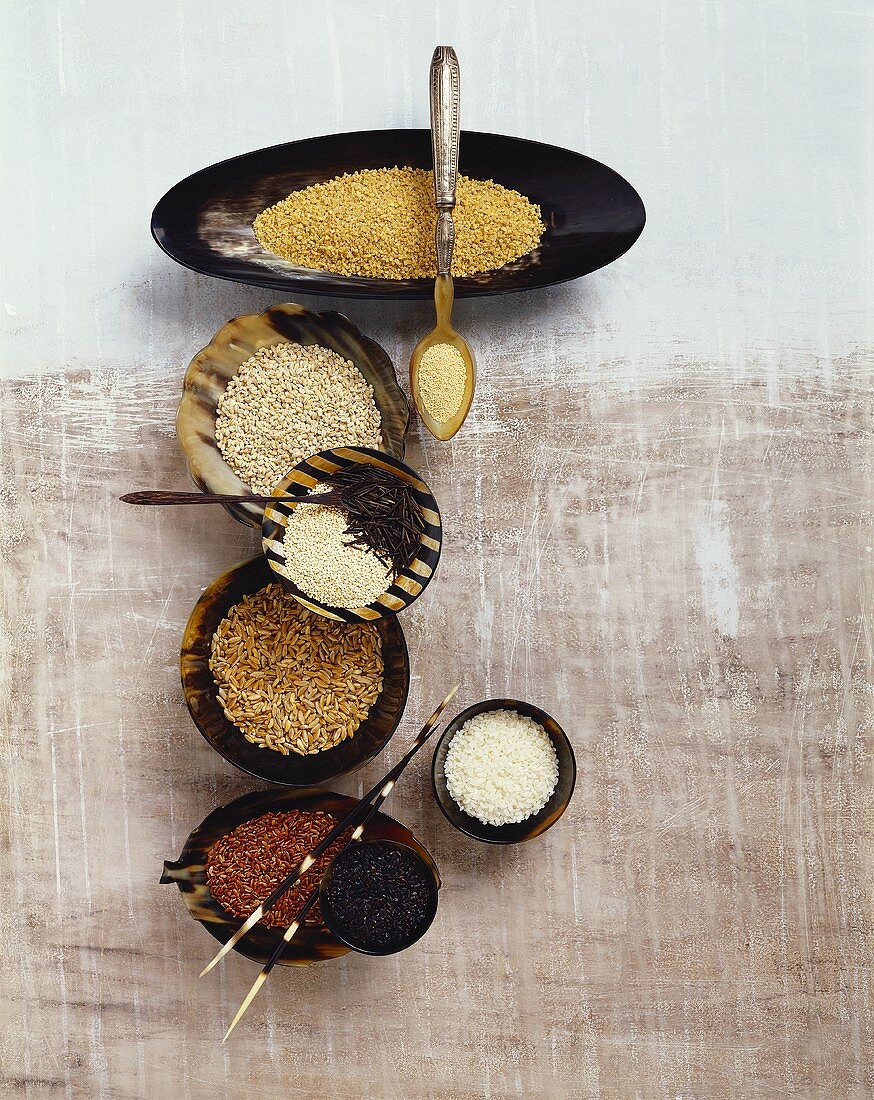 Various types of cereals and rice in small bowls