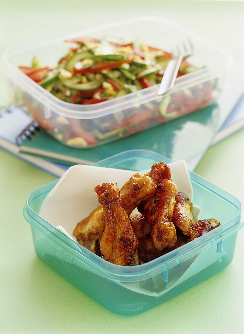 Spicy chicken thighs with salad in sandwich boxes