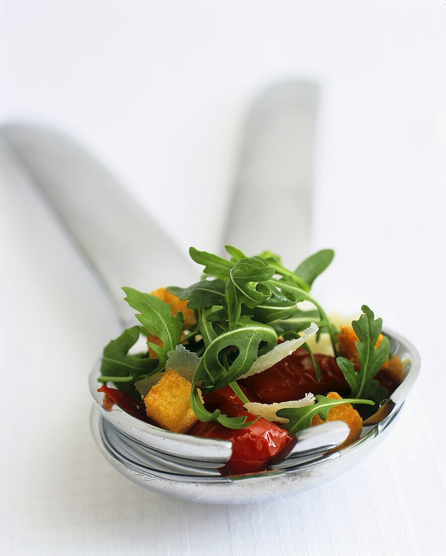 Pepper salad with rocket and Parmesan on salad servers