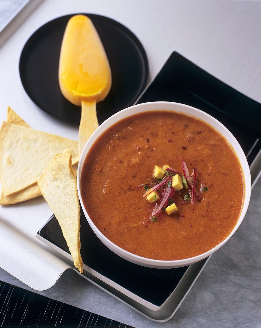 Spicy bean soup with avocado and tortilla chips