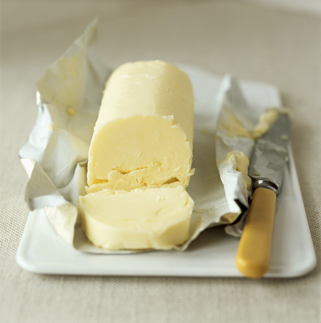 Butter with knife on paper