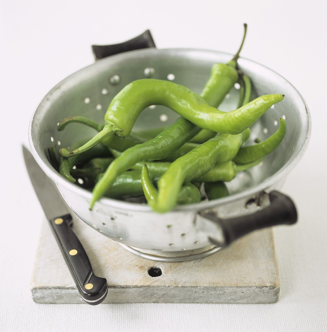 Green chili peppers in a colander