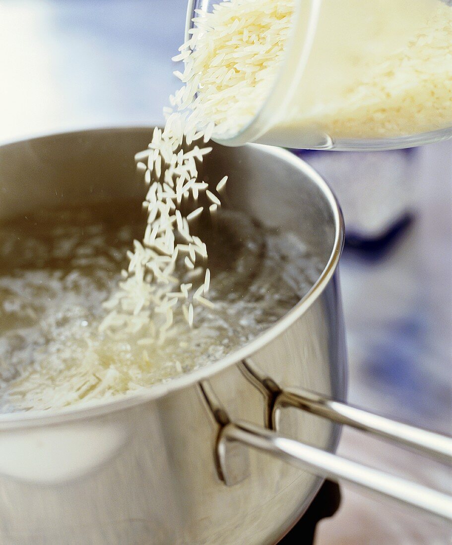 Rice being tipped into hot water