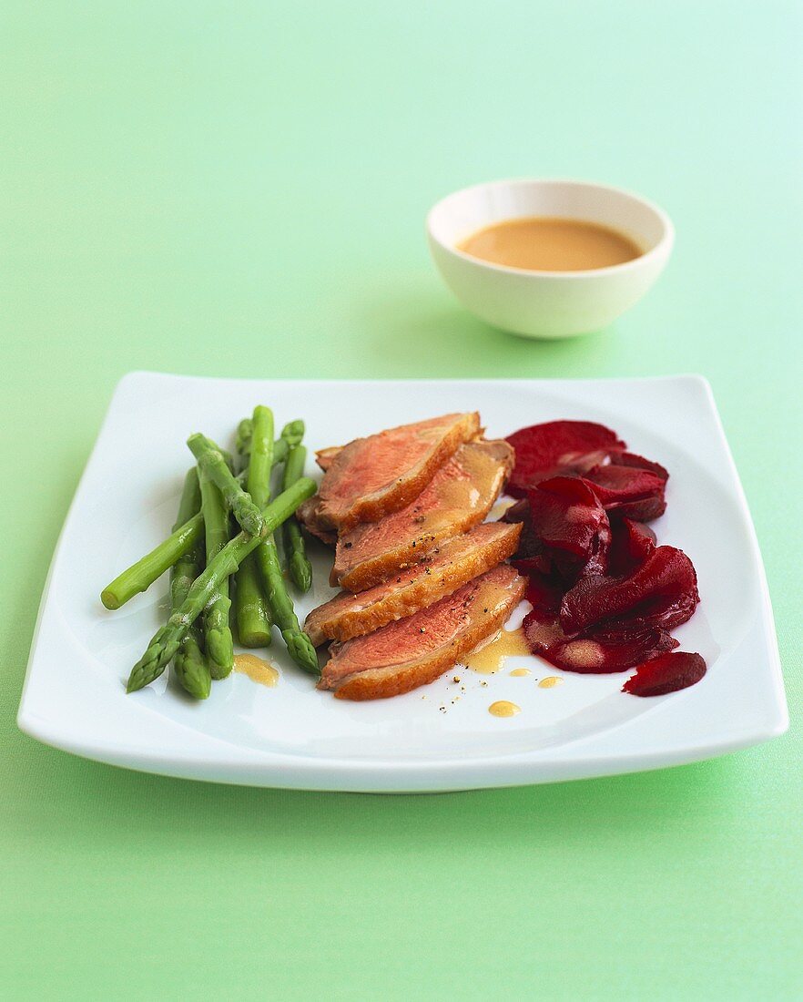 Duck with orange sauce, beetroot and green asparagus