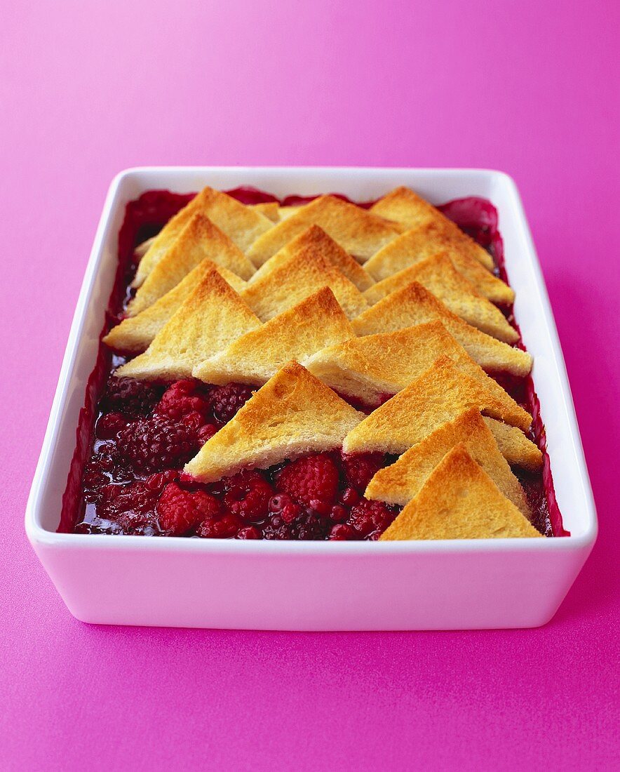 Berry compote with toast triangles in a baking dish