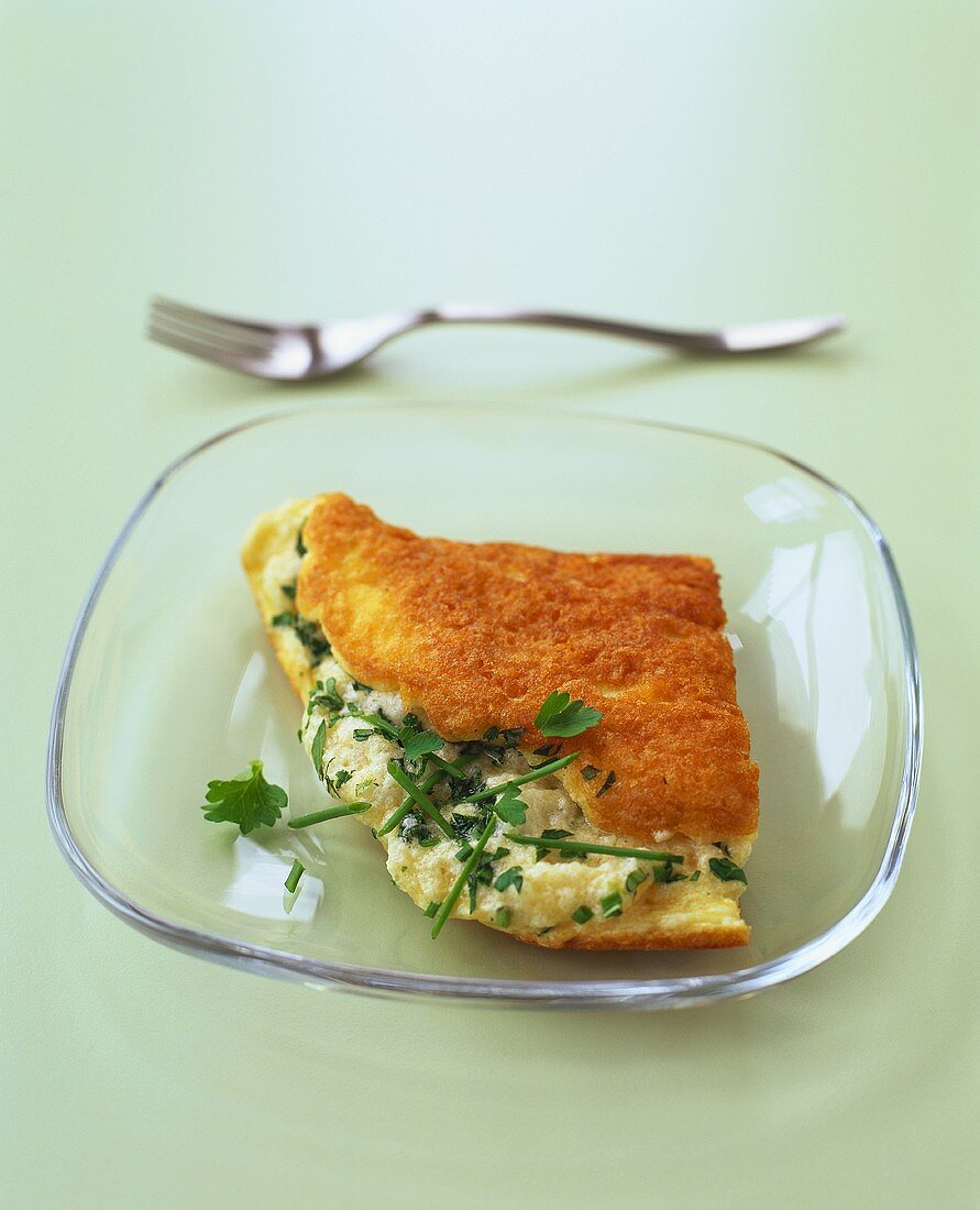 Half an omelette with cheese and onion filling and herbs
