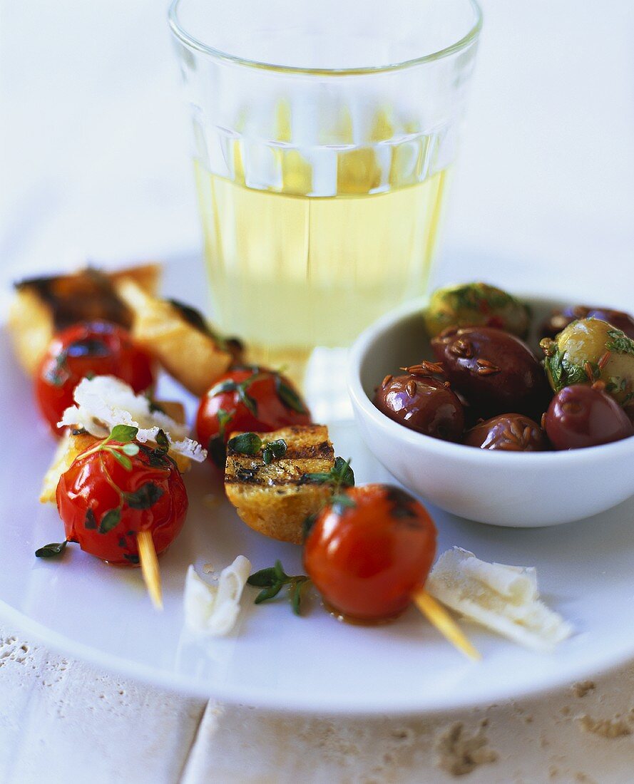 Tomato and bread kebabs and olives