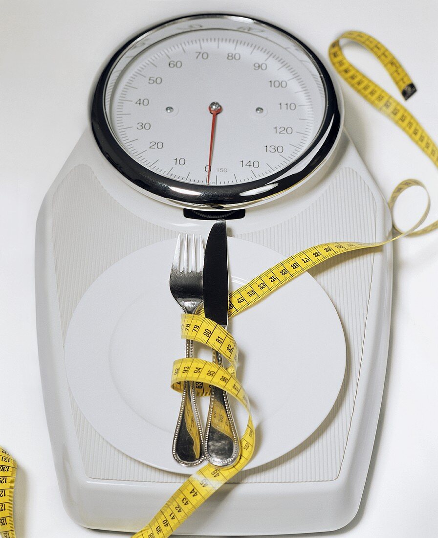 Bathroom scales with plate, cutlery and tape measure