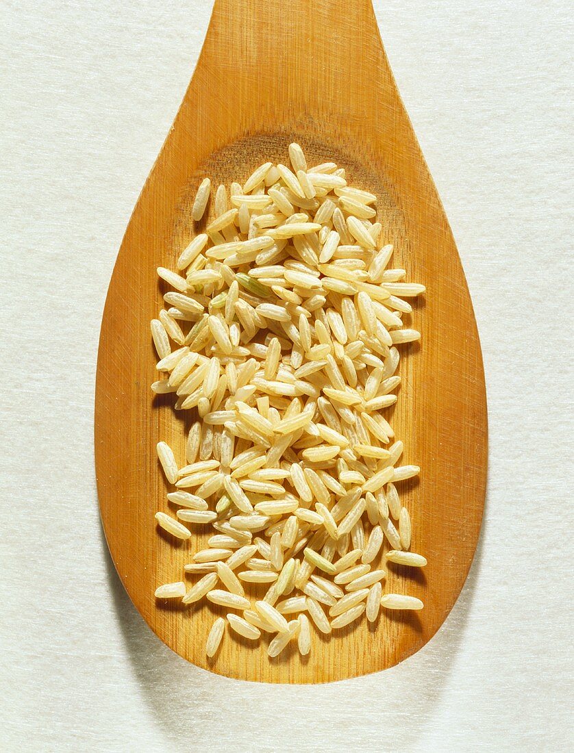 Brown rice on wooden spoon