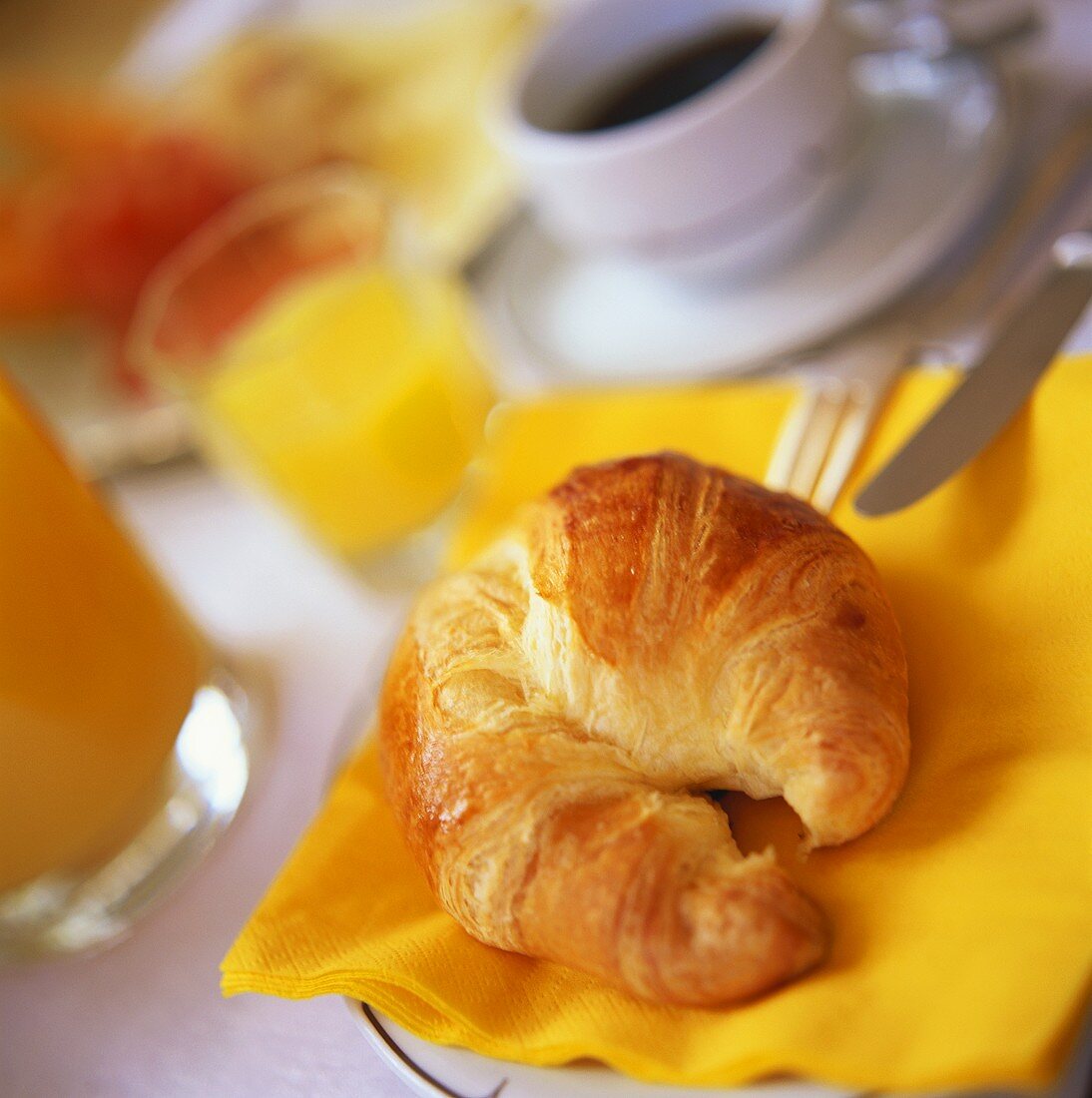 Croissant, coffee and orange juice for breakfast