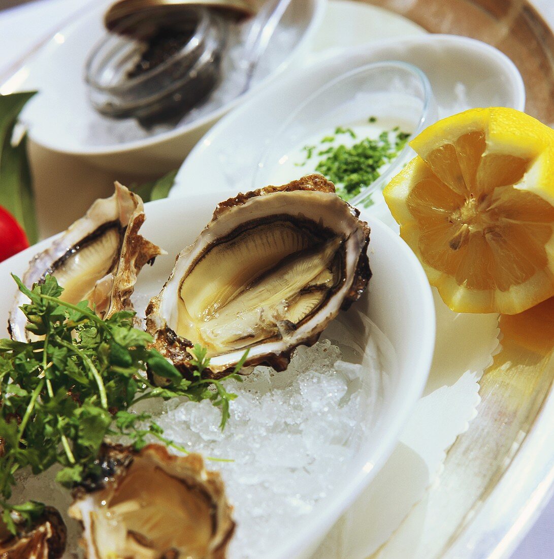 Fresh oysters on ice; lemons; caviare