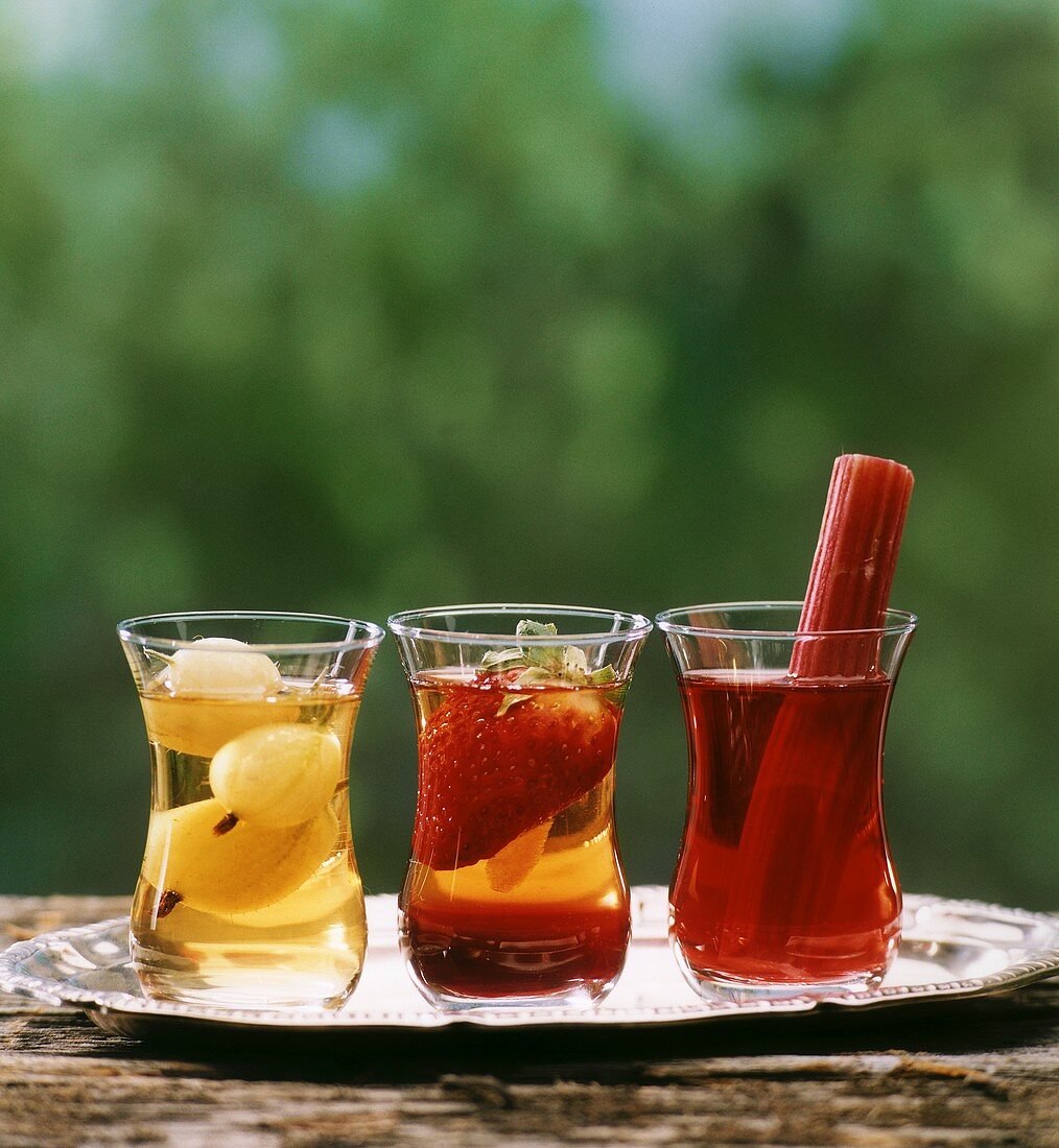 Three glasses of iced tea with fruit
