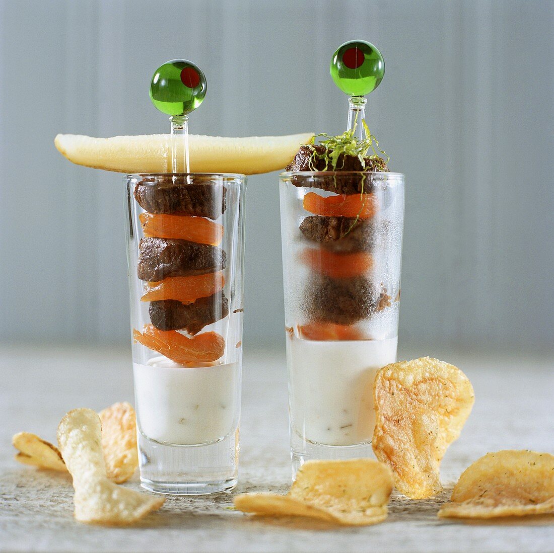 Skewered meat and apricots on yoghurt dip