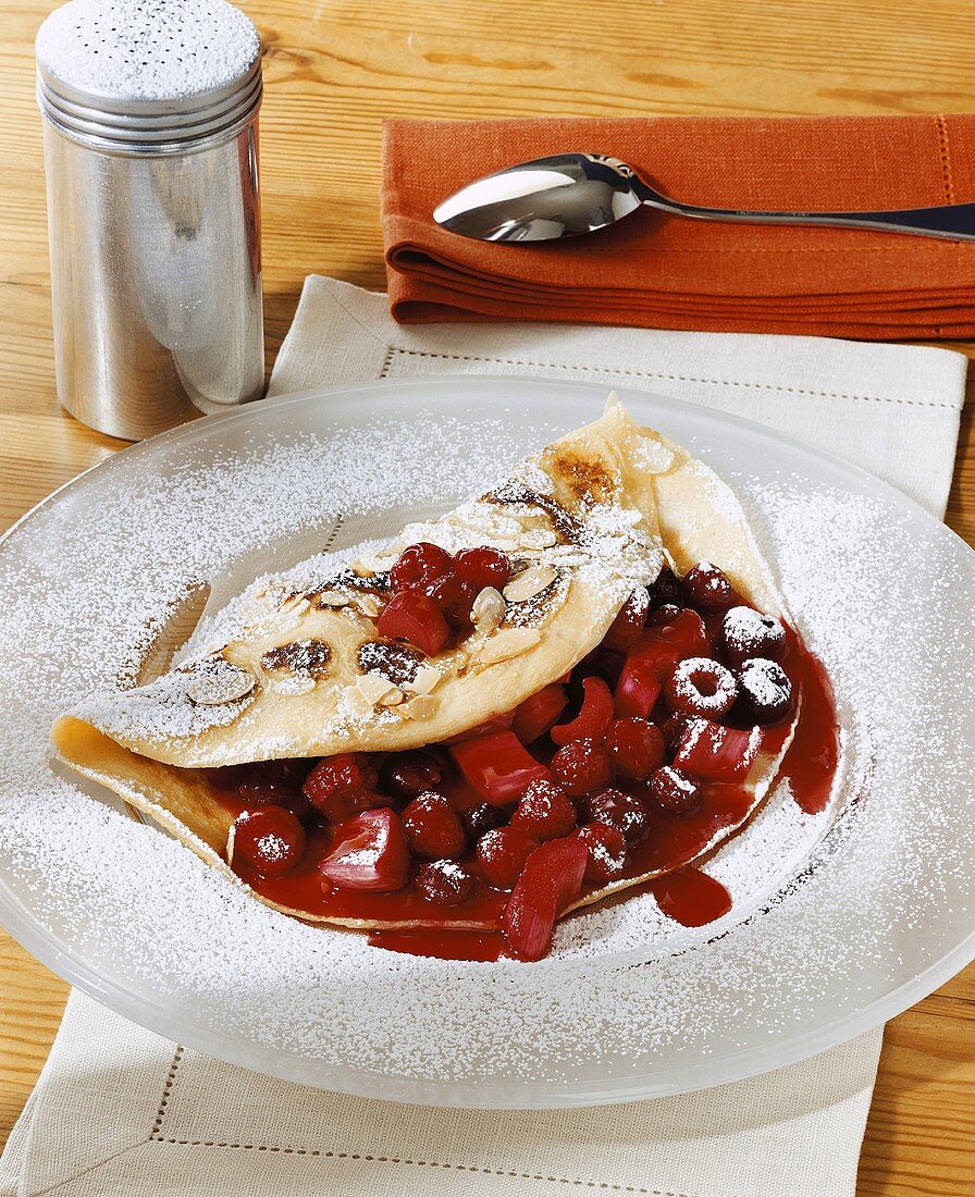 Almond pancakes with raspberry and cherry filling