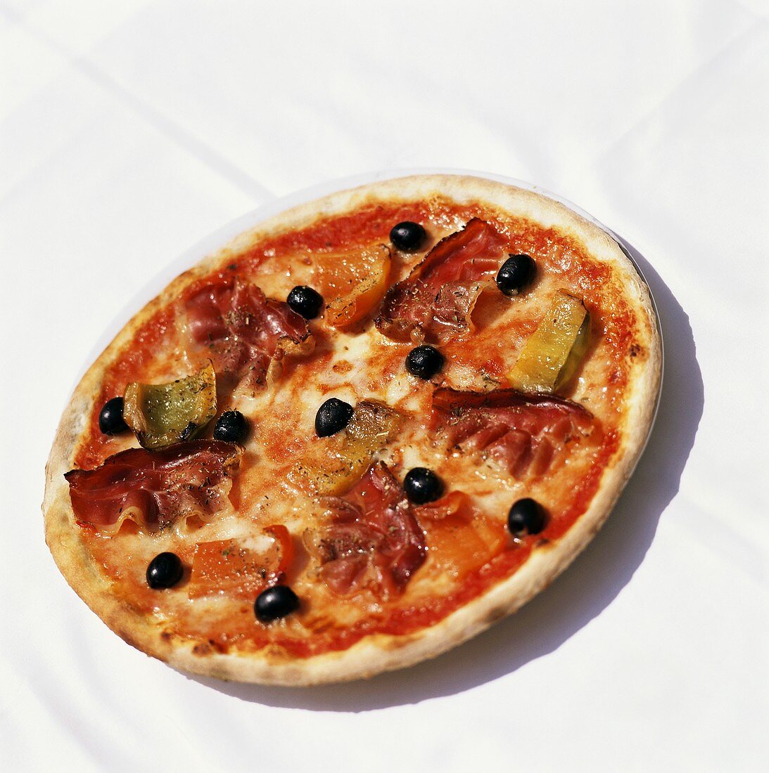 Pizza with bacon, peppers and black olives