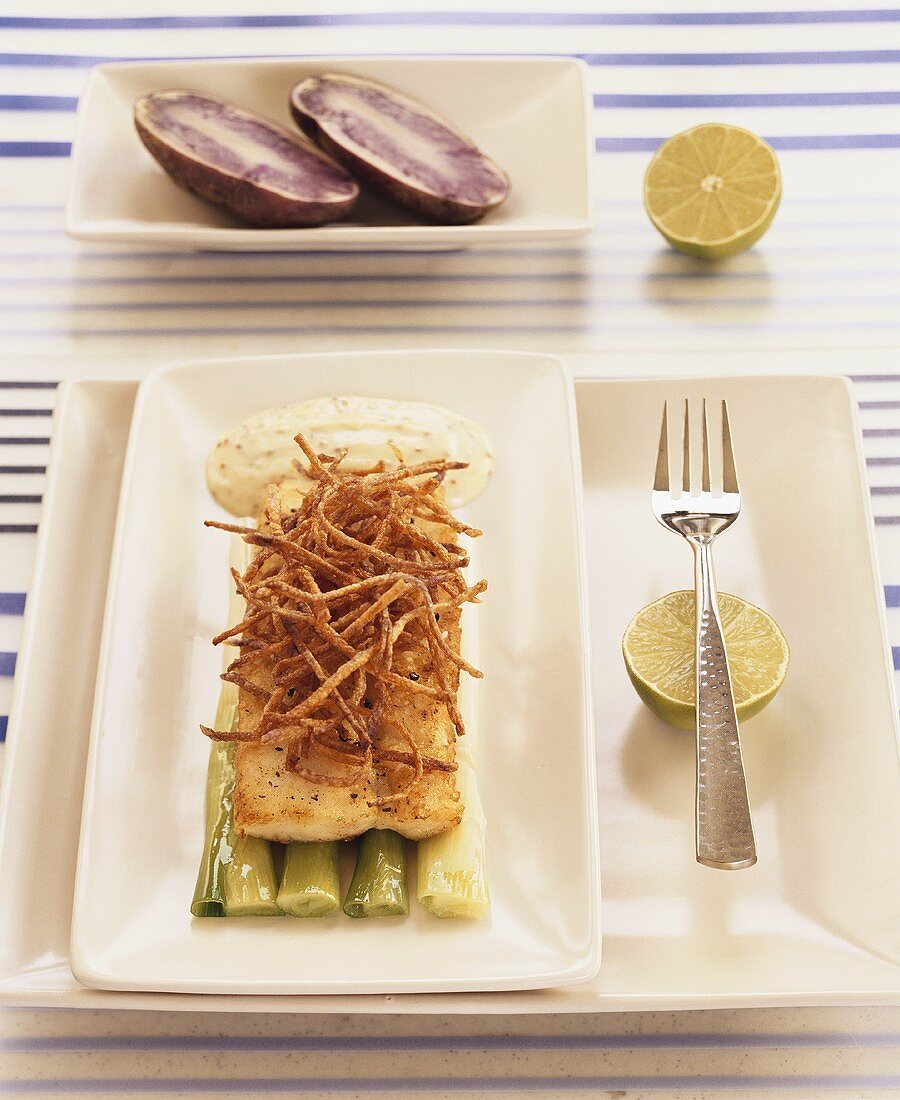 Grouper fillet with straw potatoes on spring onion