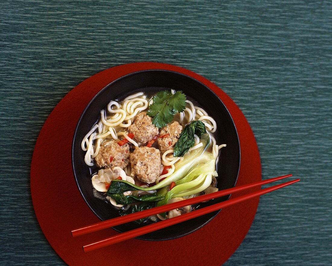 Asian noodle soup with pak choi and meatballs