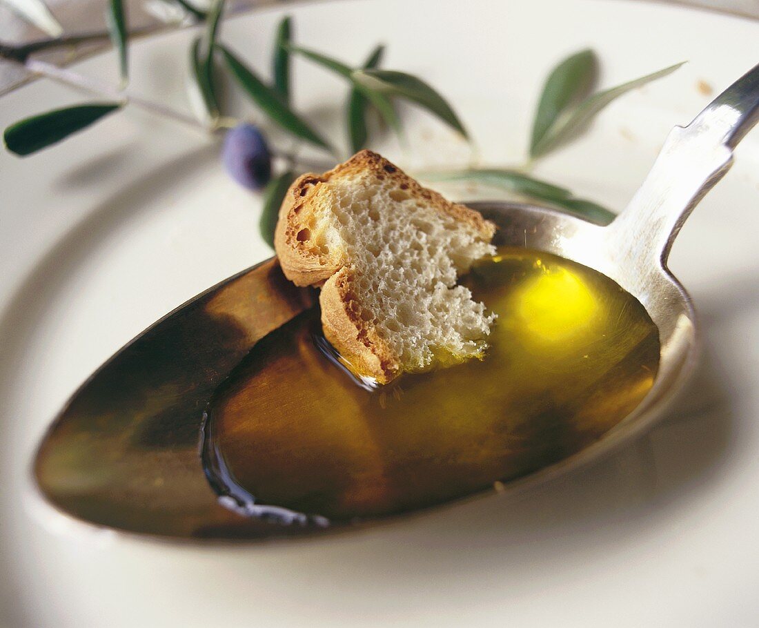 Löffel mit Olivenöl und Weißbrot