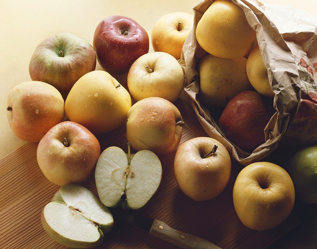 Various types of apples out of a paper bag