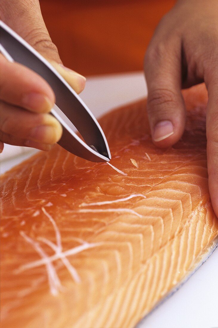 Removing the pin bones from a salmon fillet