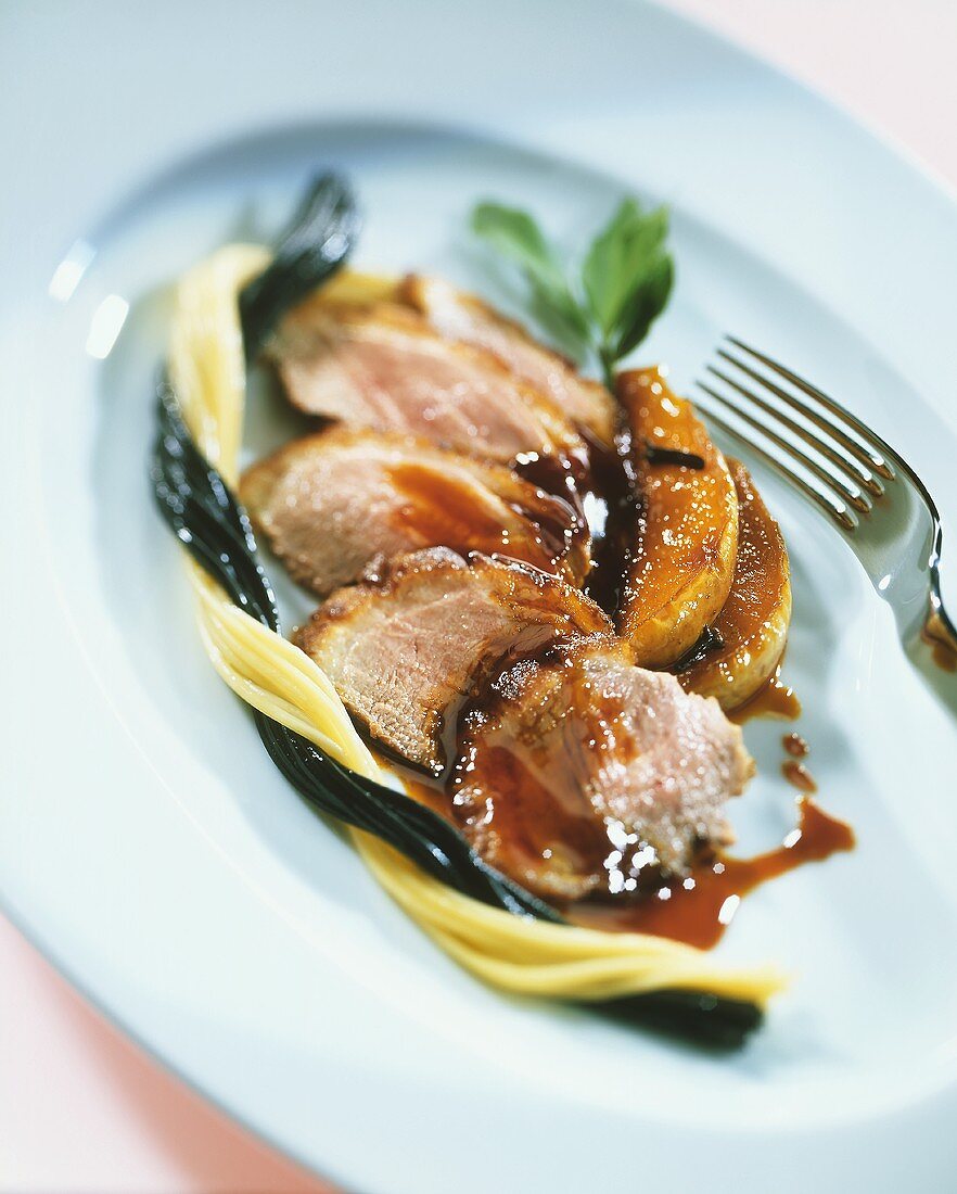 Duck breast with Cassis pear and black and white spaghetti
