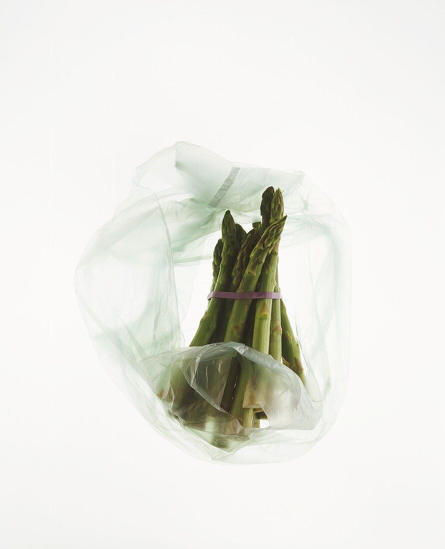 A bundle of green asparagus in plastic bag