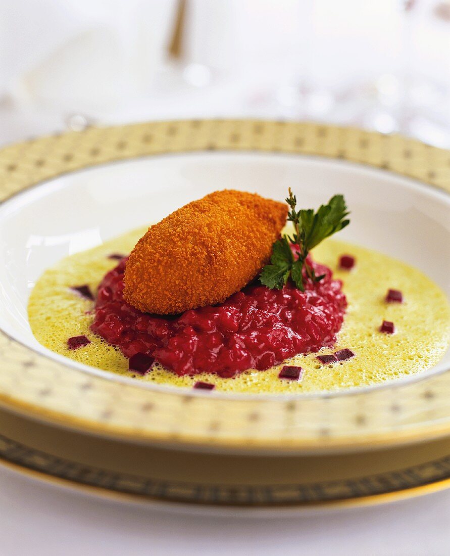 Vegetable croquette with beetroot risotto on watercress whip