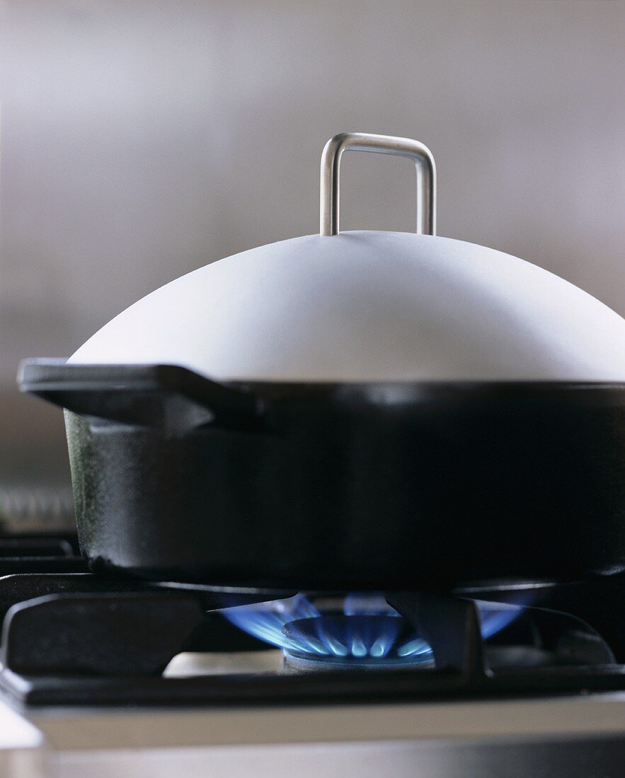 Pan with lid on gas cooker